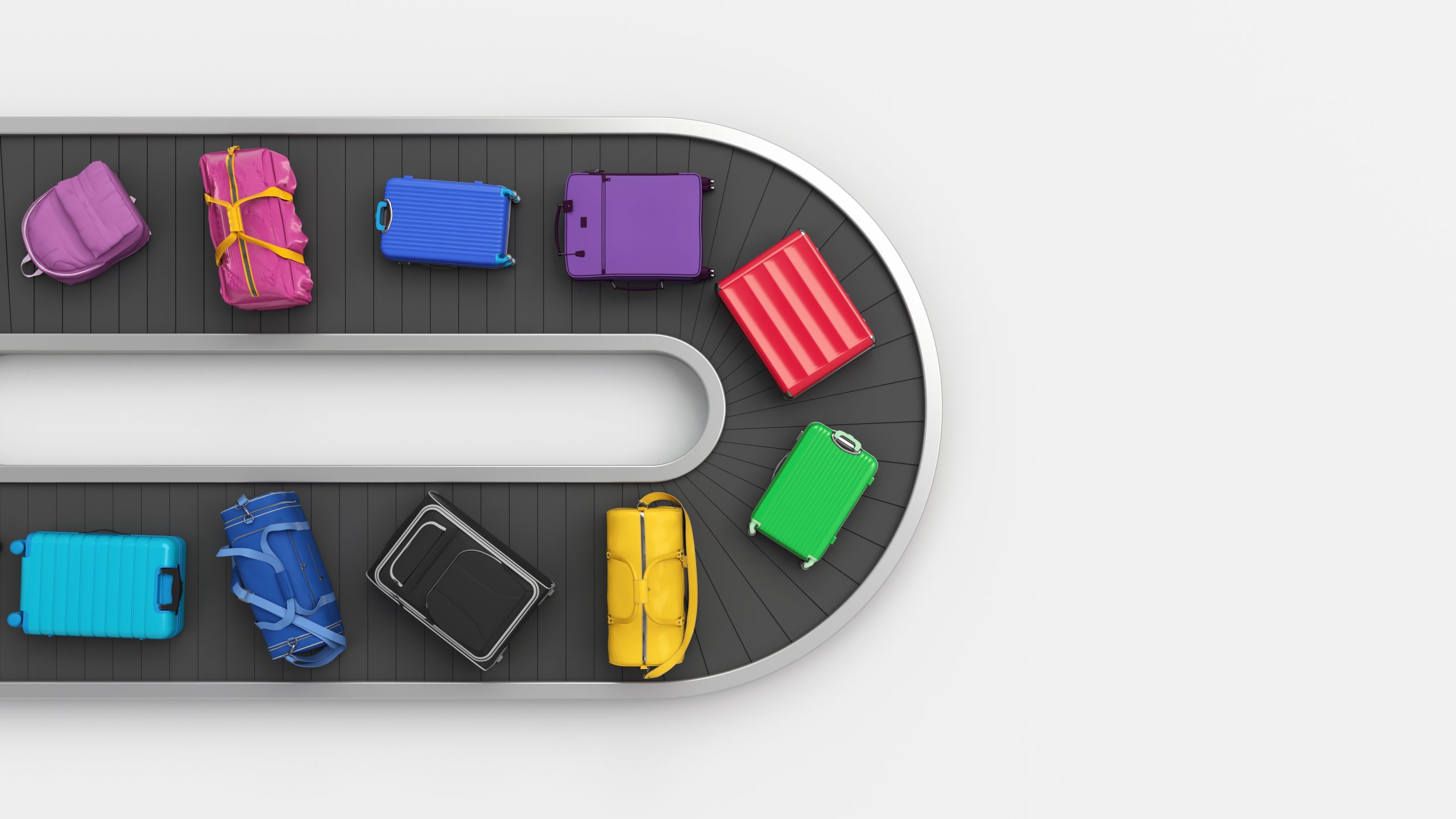 multicolored suitcases on a curved conveyor to illustrate conveyor system terms